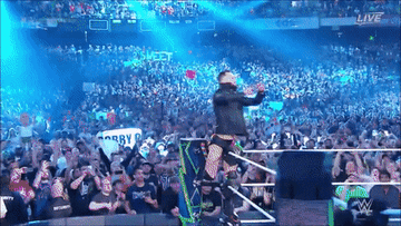 Finn Balor raising his arms and the crowd doing the same