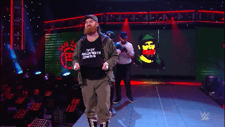 Sami Zayn walking to the ring with a camera crew