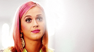 Katy Perry shrugs and smiles