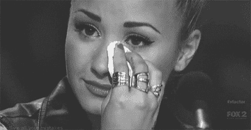 Demi Lovato blots away tears