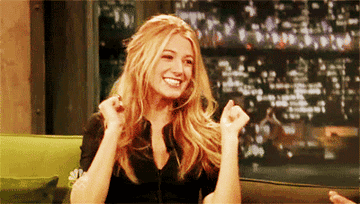 Blake Lively waving her fists with her mouth wide open in excitement.
