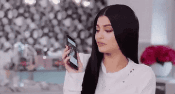 Kylie Jenner kisses her iPhone