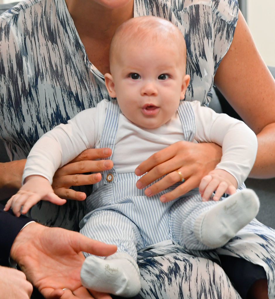 Meghan Markle holds baby Archie during a meet-and-greet with Archbishop Desmond Tutu and his daughter Thandeka Tutu-Gxashe