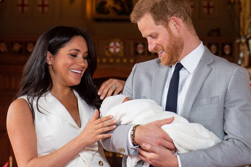 Prince Harry (R), and his wife Meghan Markle, pose for a photo with their newborn baby son, Archie Harrison Mountbatten-Windsor