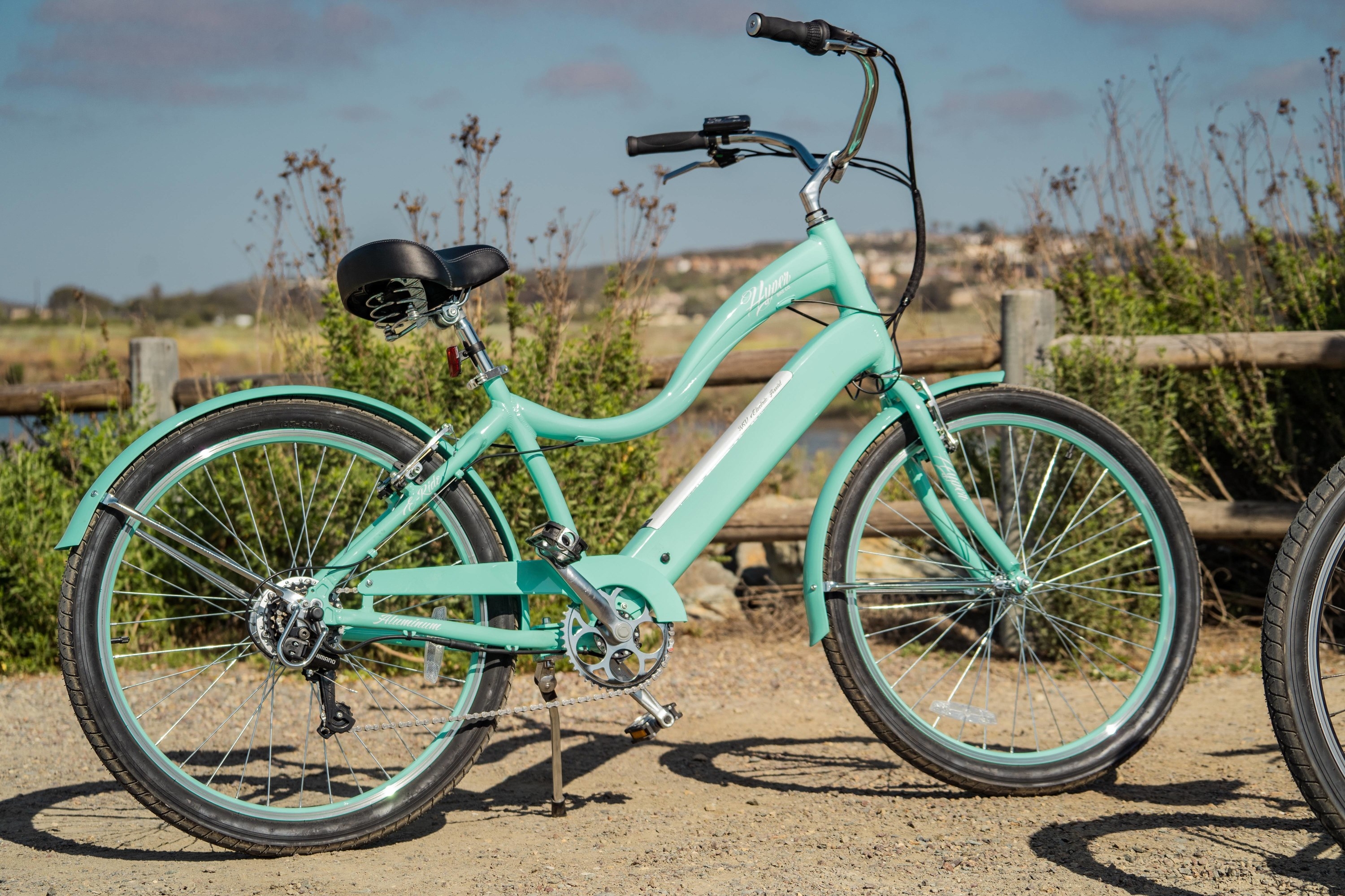 the turquoise bike on a dirt road
