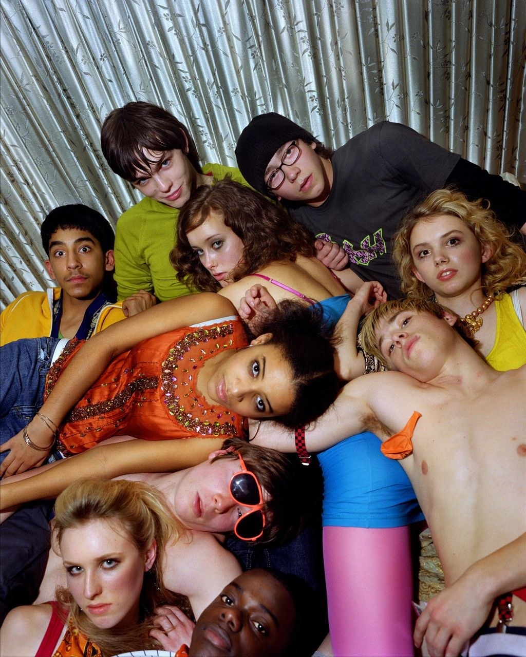 The cast of the TV show Skins lying in a heap around each other