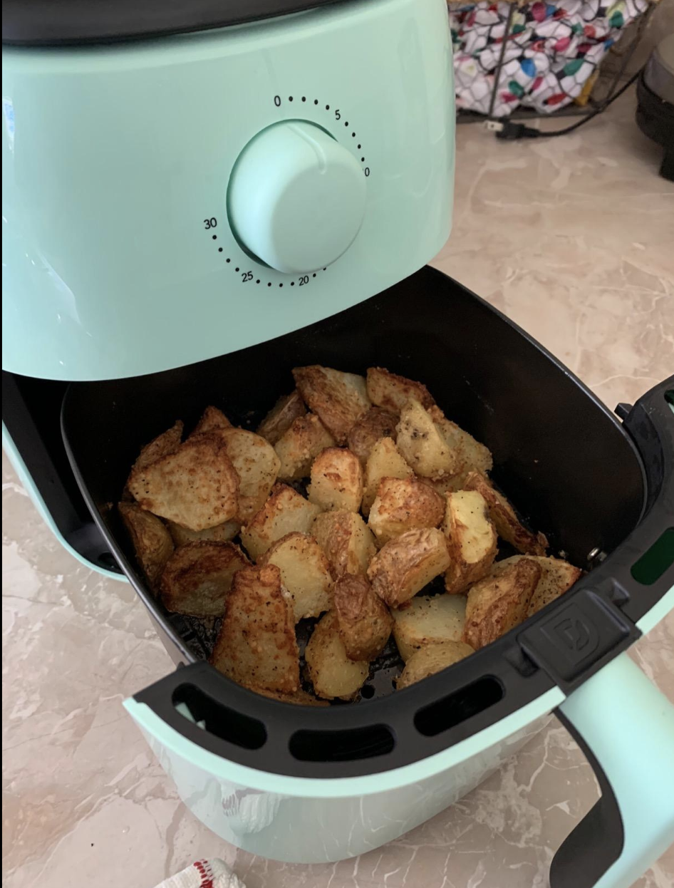 Reviewer image of tater tots in the blue air fryer shelf