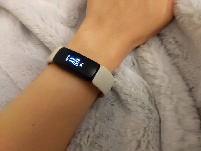 a reviewer&#x27;s wrist with the fitbit on