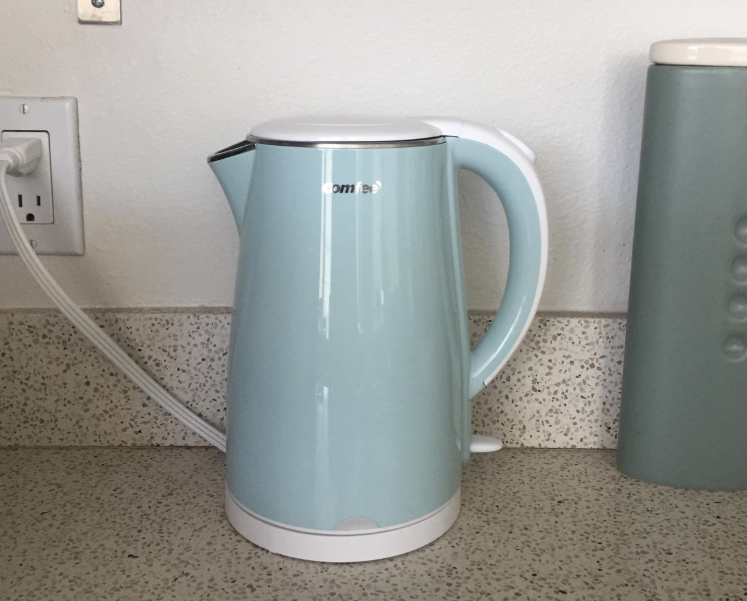 Mint green tea kettle on a kitchen counter