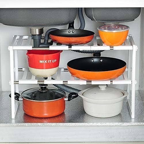 Stainless steel under sink storage organiser holding pots and pans