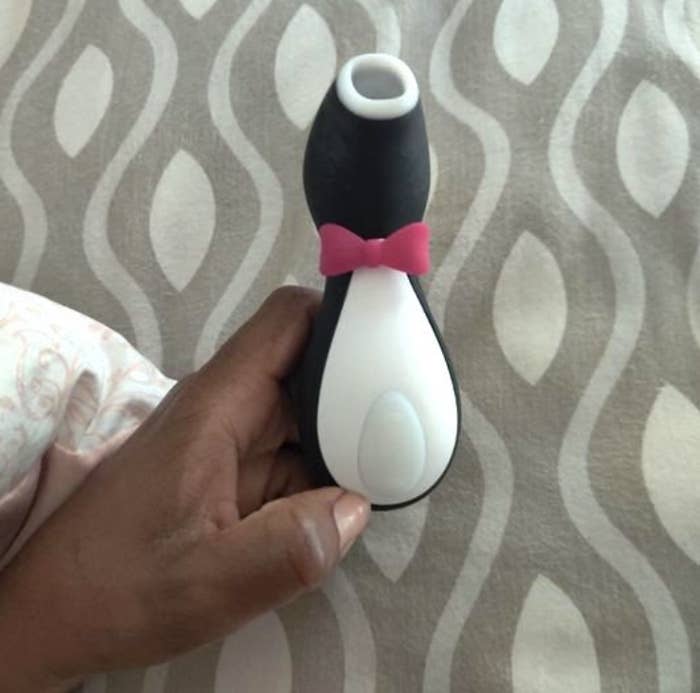 Reviewer holding the penguin-shaped vibrator