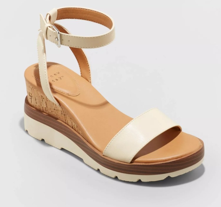 A pair of faux leather sandals with a wedge heel
