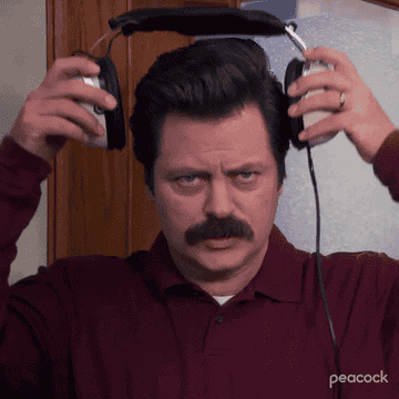 Ron Swanson putting on over the ear headphones