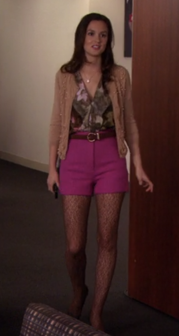 Blair in tights, high waisted shorts, a buckle belt, a leaf pattern v neck ruffle blouse, and an open cardigan with pearls sewn on