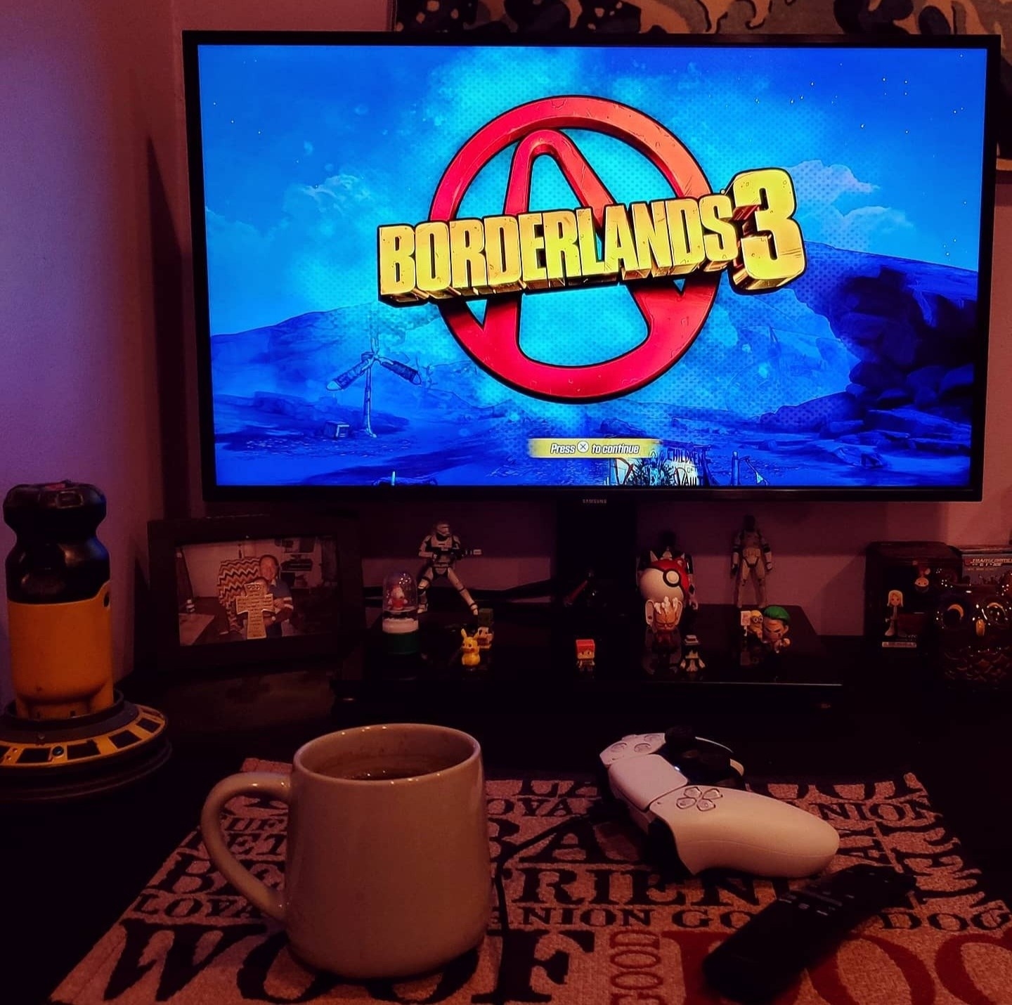 reviewer photo of the TV hooked up to a gaming set up, displaying the Borderlands 3 game loading screen
