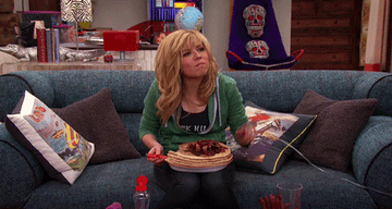 Sam with a plate of pancakes on her lap in a scene from the original show