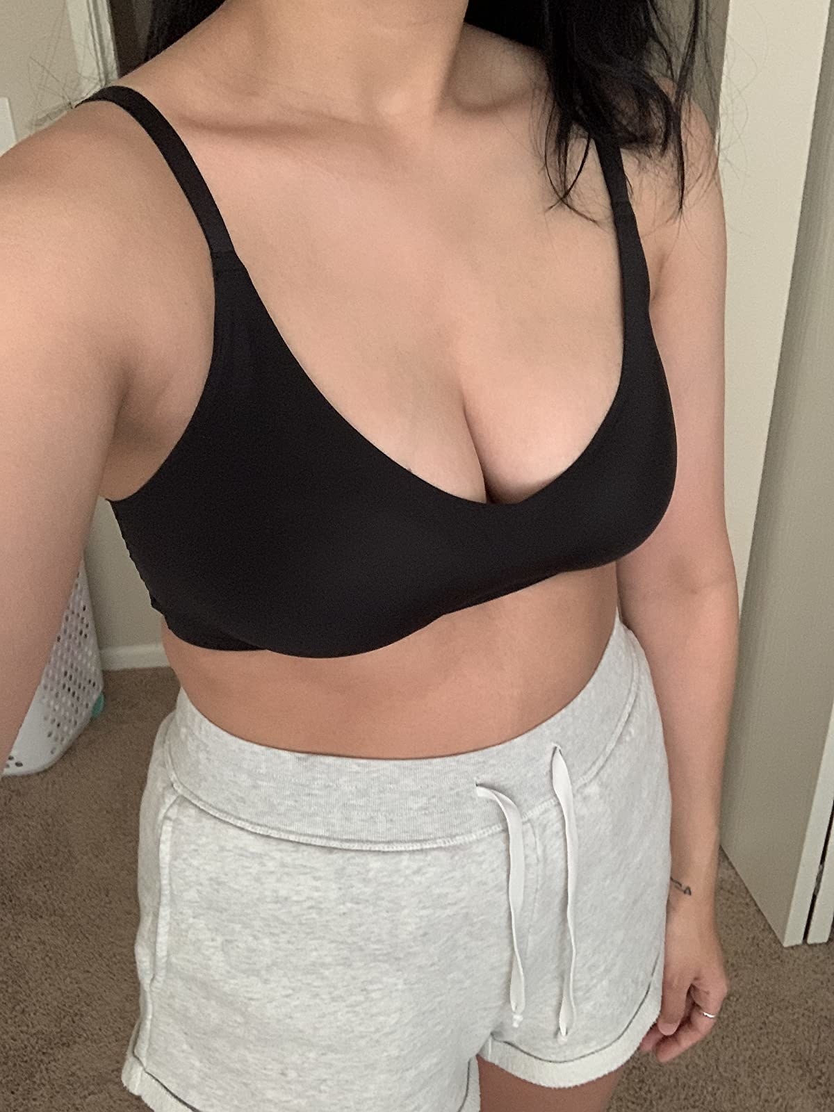 a reviewer wearing the bra in black with gym shorts 