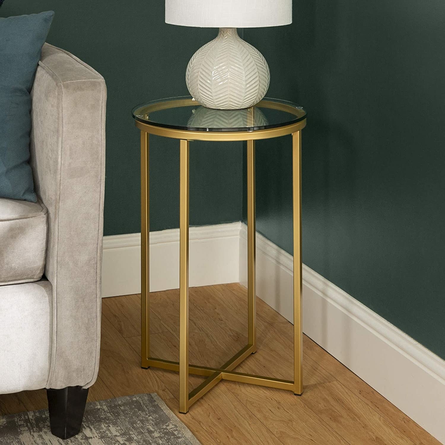 Round accent table with glass top and gold metal base