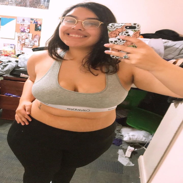 reviewer wearing the bra in grey
