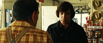 Javier Bardem flipping a coin in &quot;No Country For Old Men.&quot;
