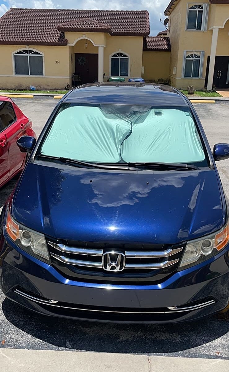 a reviewer photo of a car with the shun shields covering the entire front window