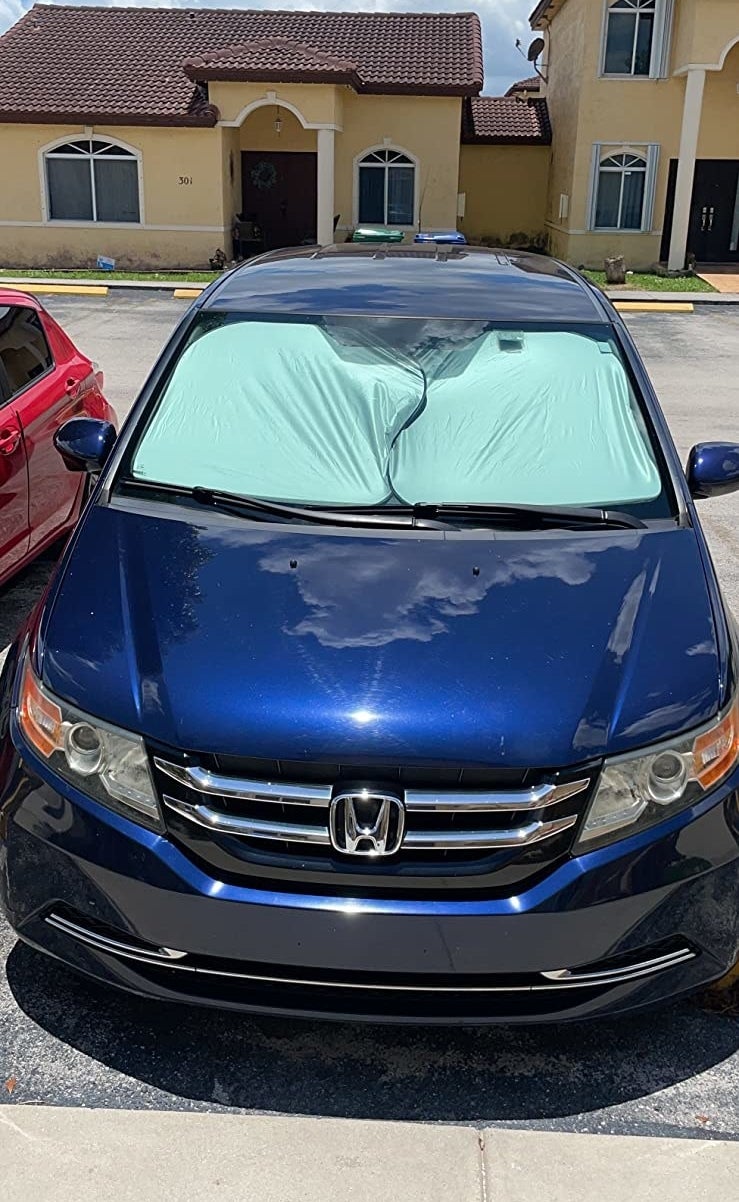 a reviewer photo of a car with the shun shields covering the entire front window