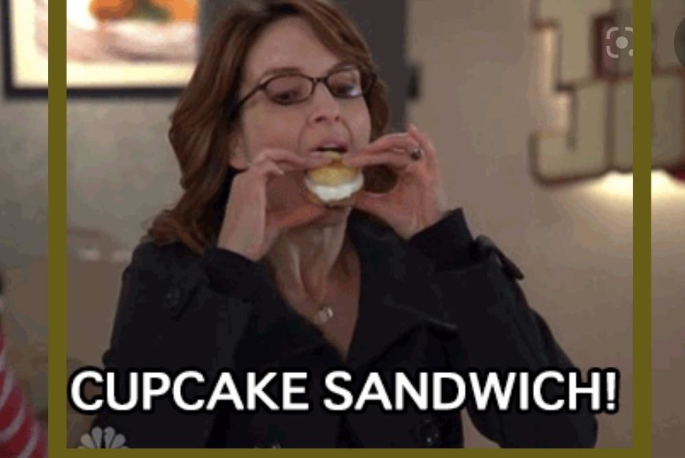 Tina Fey eating a cupcake sandwich.