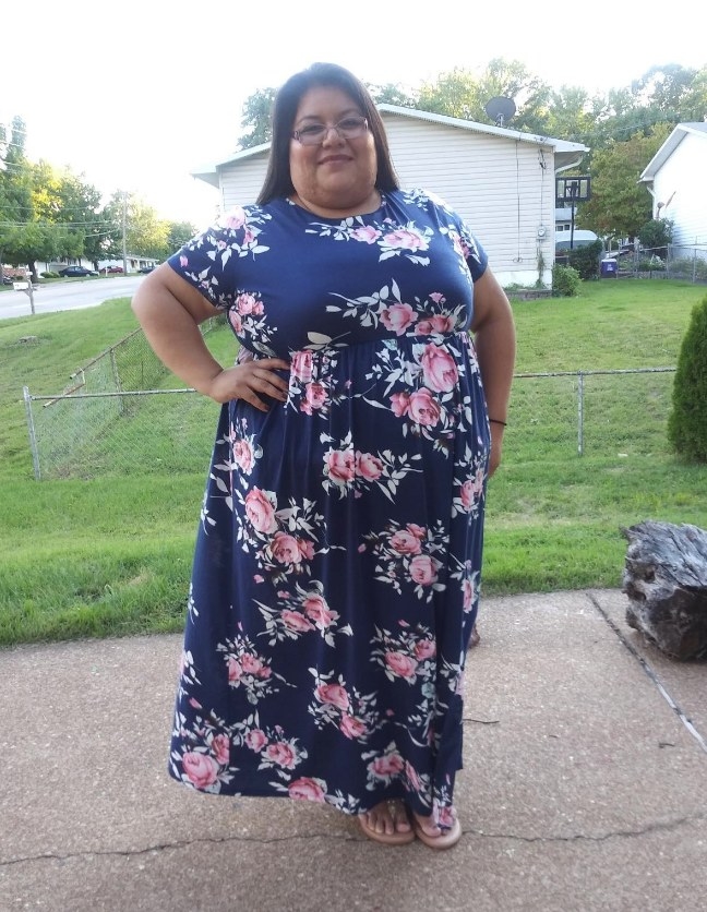 A reviewer wearing a short sleeve, maxi dress with pockets in &quot;143navyprint&quot;