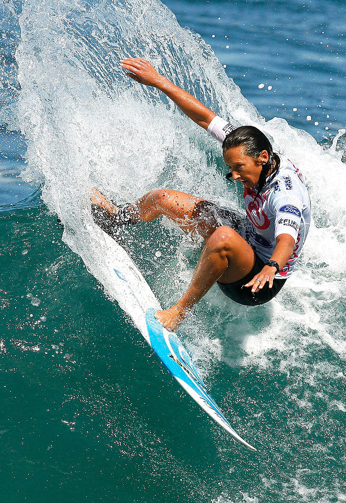 Layne Beachley, an Australian surfer, surfing a wave during a competition