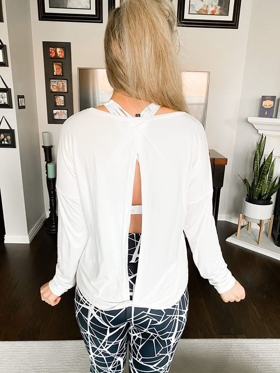 reviewer showing the open back design of the top