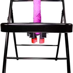 Folding chair with pink realistic dildo in center hole