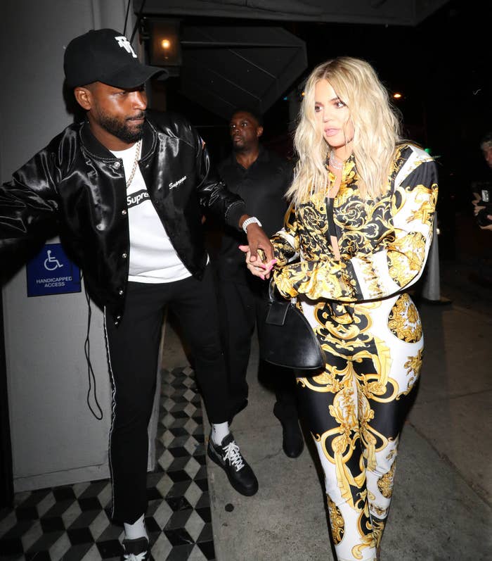 Tristan gets the door for Khloe outside a building in Los Angeles