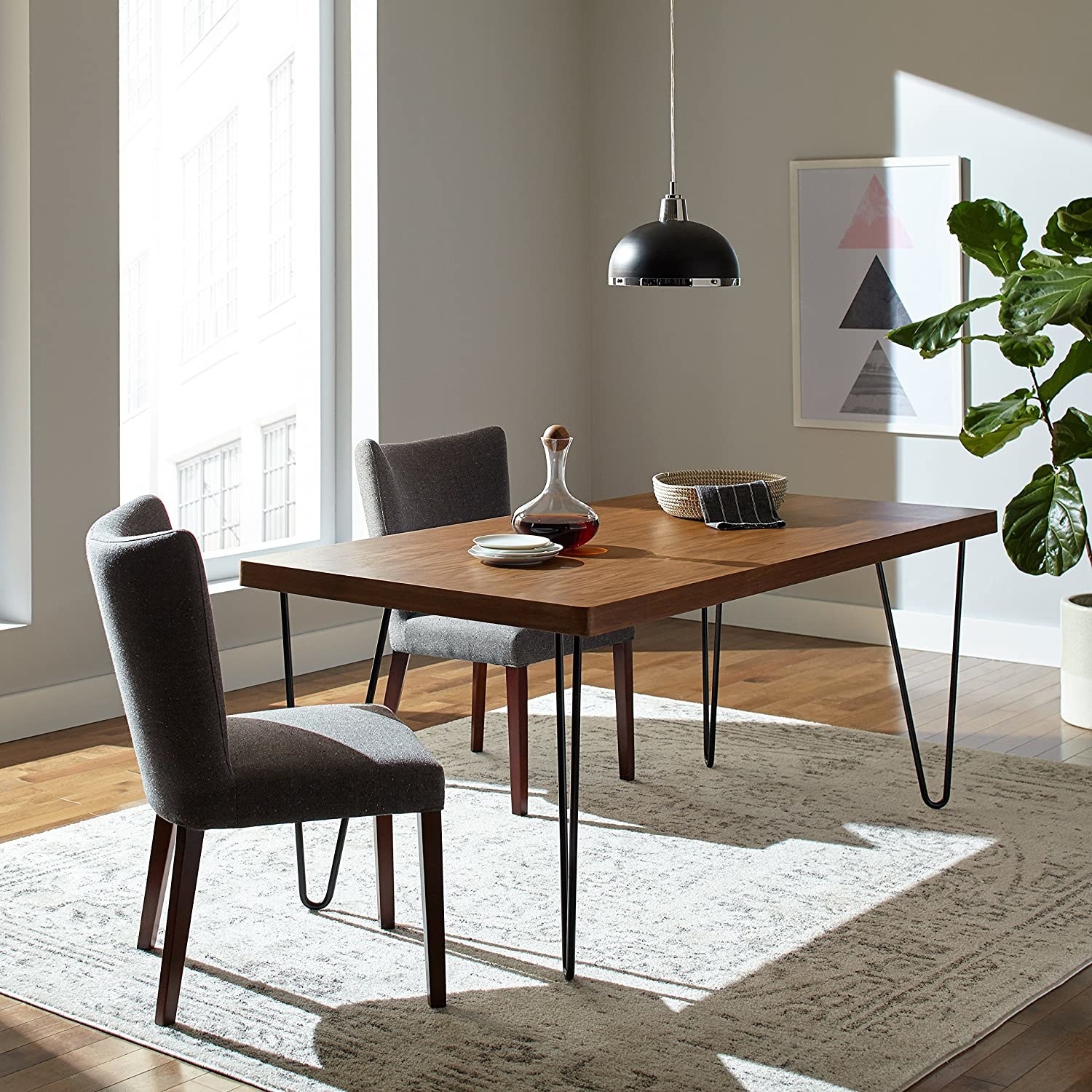 Wooden dining table with two gray chairs