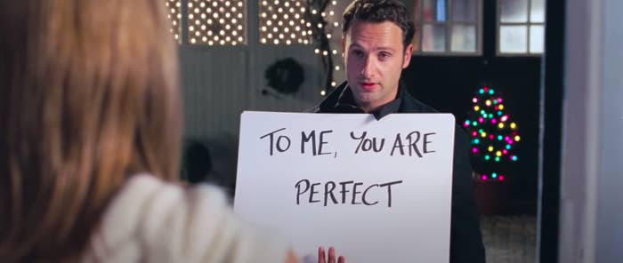 The card guy from &quot;Love Actually&quot; holding the card that says, &quot;To me, you are perfect&quot;
