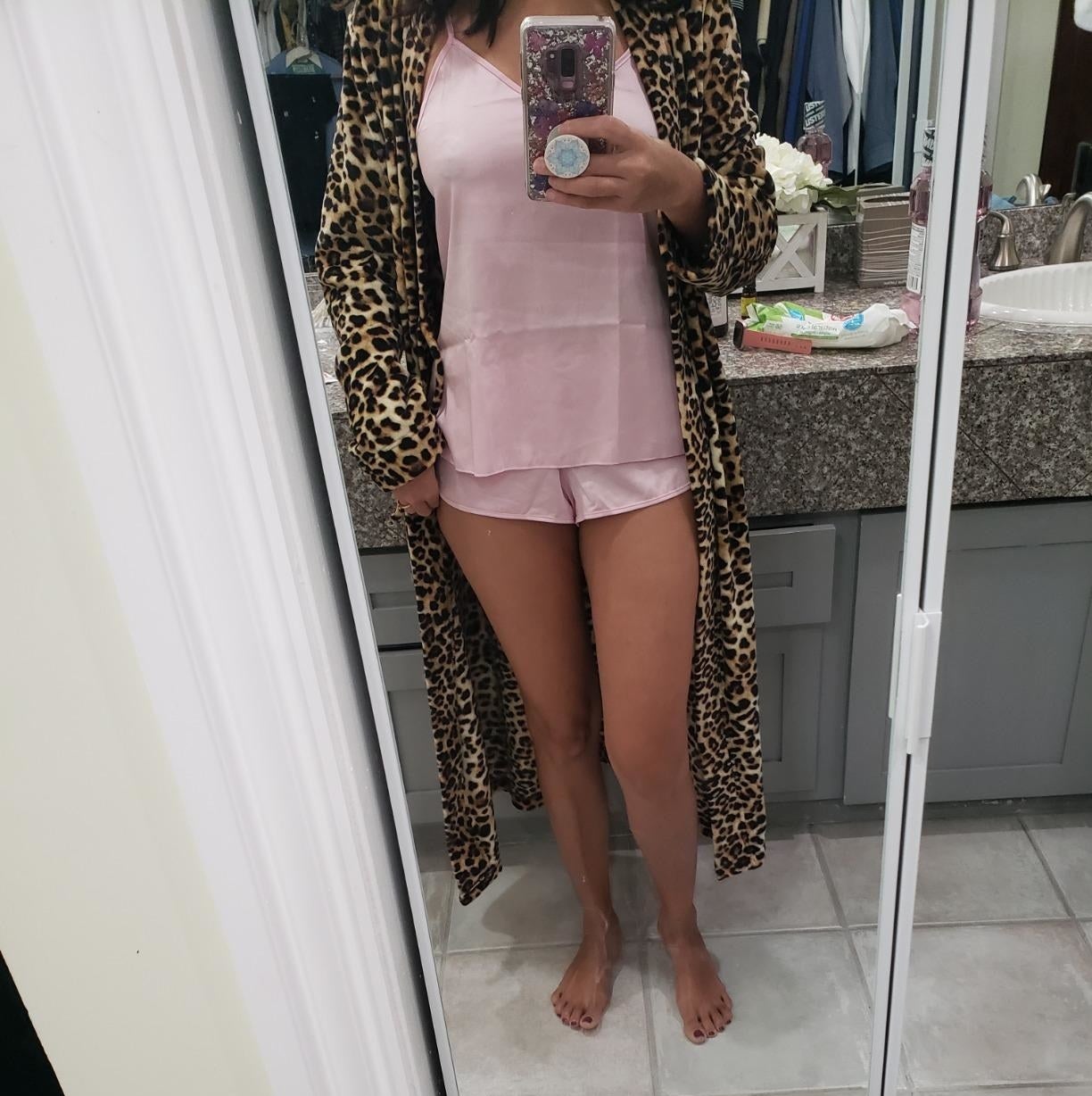 reviewer wearing the set in pink with a robe over