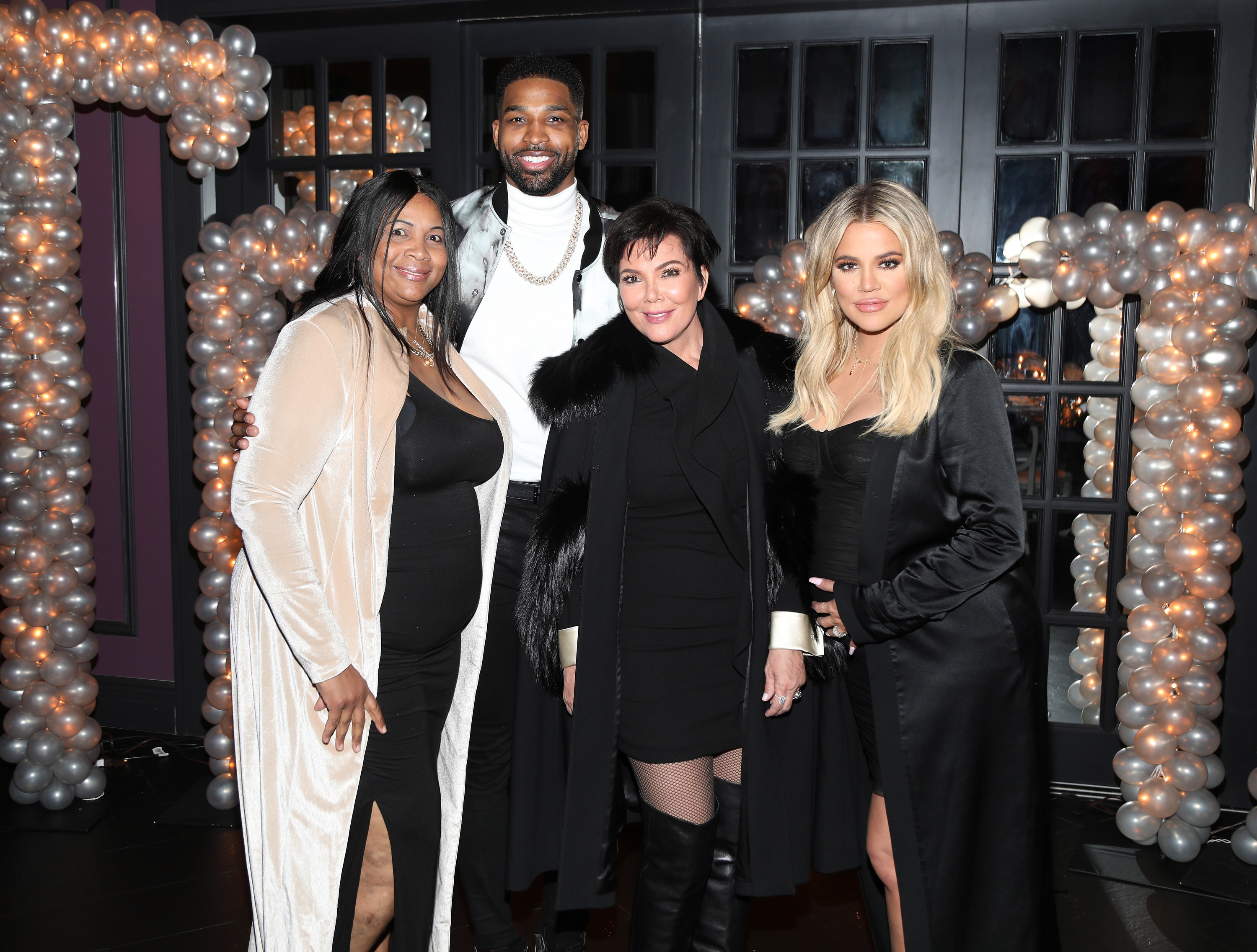 Andrea and Tristan Thompson and Khloe Kardashian and Kris Jenner all pose for a photo together at an event