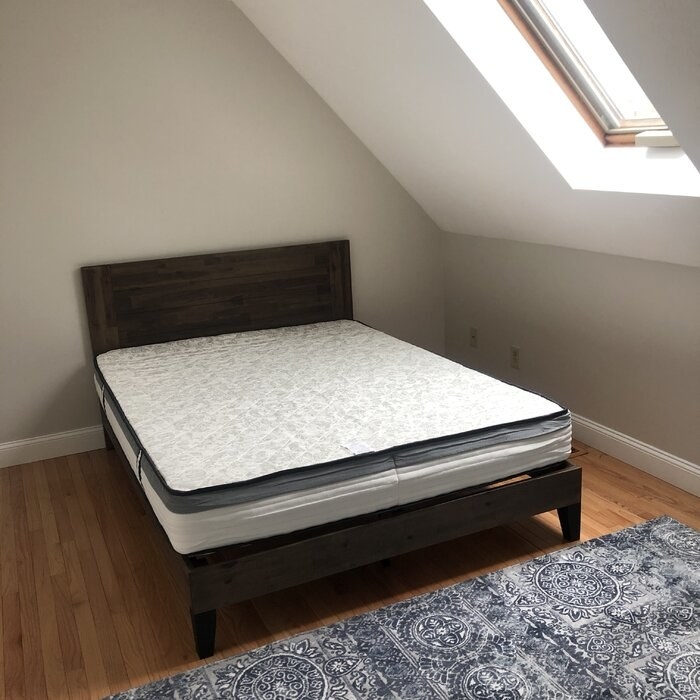 The bed frame with a mattress on top