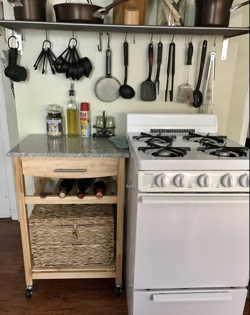 Reviewer's island is next to the stove and is holding kitchen supplies