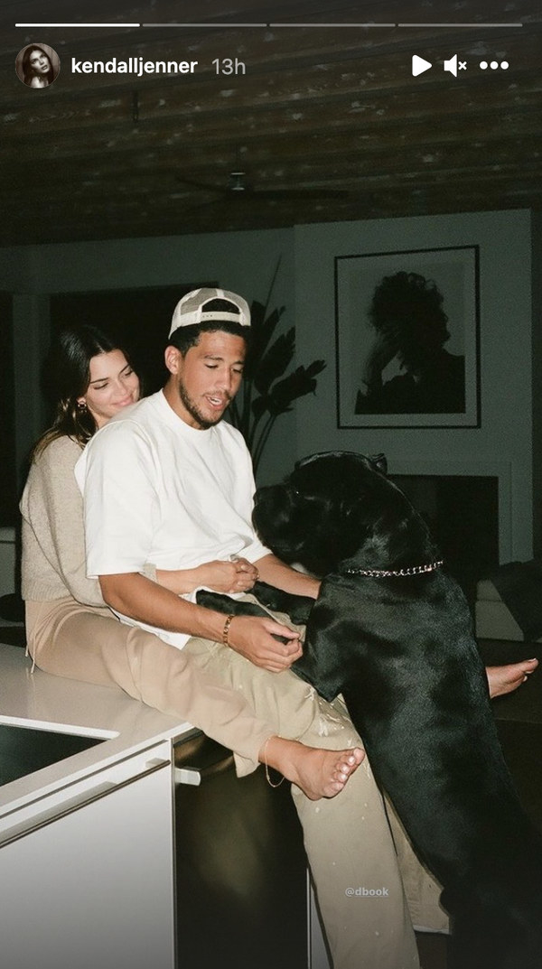 Kendall Jenner wraps her arms around Devin Booker&#x27;s waist as his dog hops up on his lap