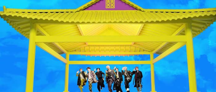 BTS dance in sync wearing traditional Korean clothing in the Idol music video