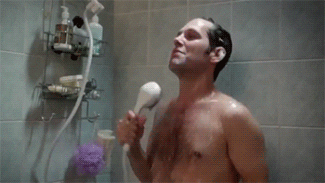 Gif of Paul Rudd massaging himself with a shower head and giggling
