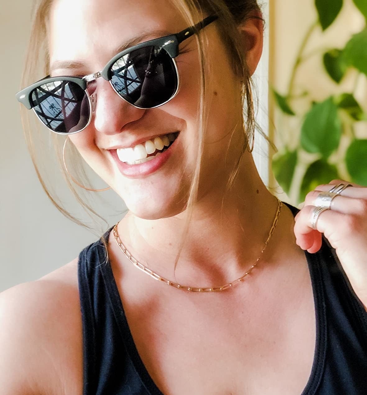 Reviewer is wearing sunglasses and smiling