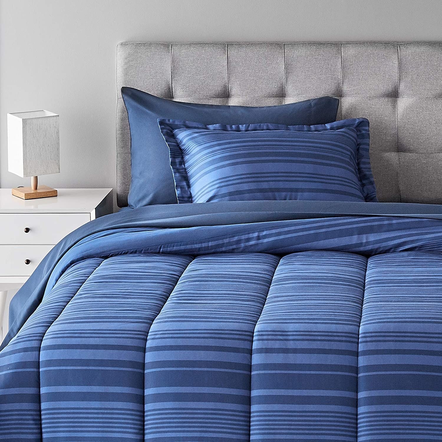 Blue striped comforter and pillowcases on a bed