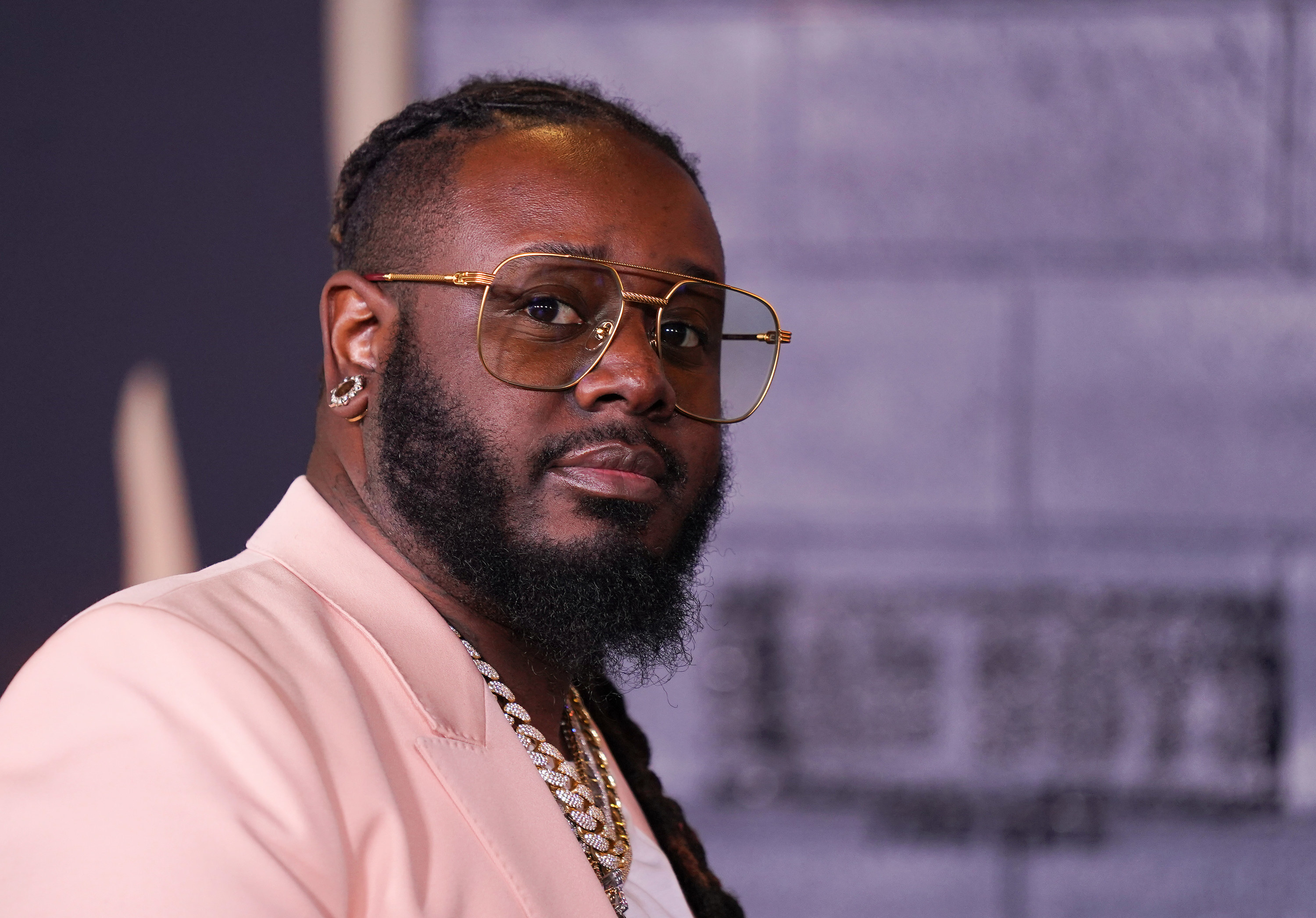 T-pain looks unsure while looking at the camera
