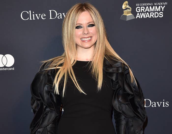 Avril smiles at a recent event in a long sleeve black dress