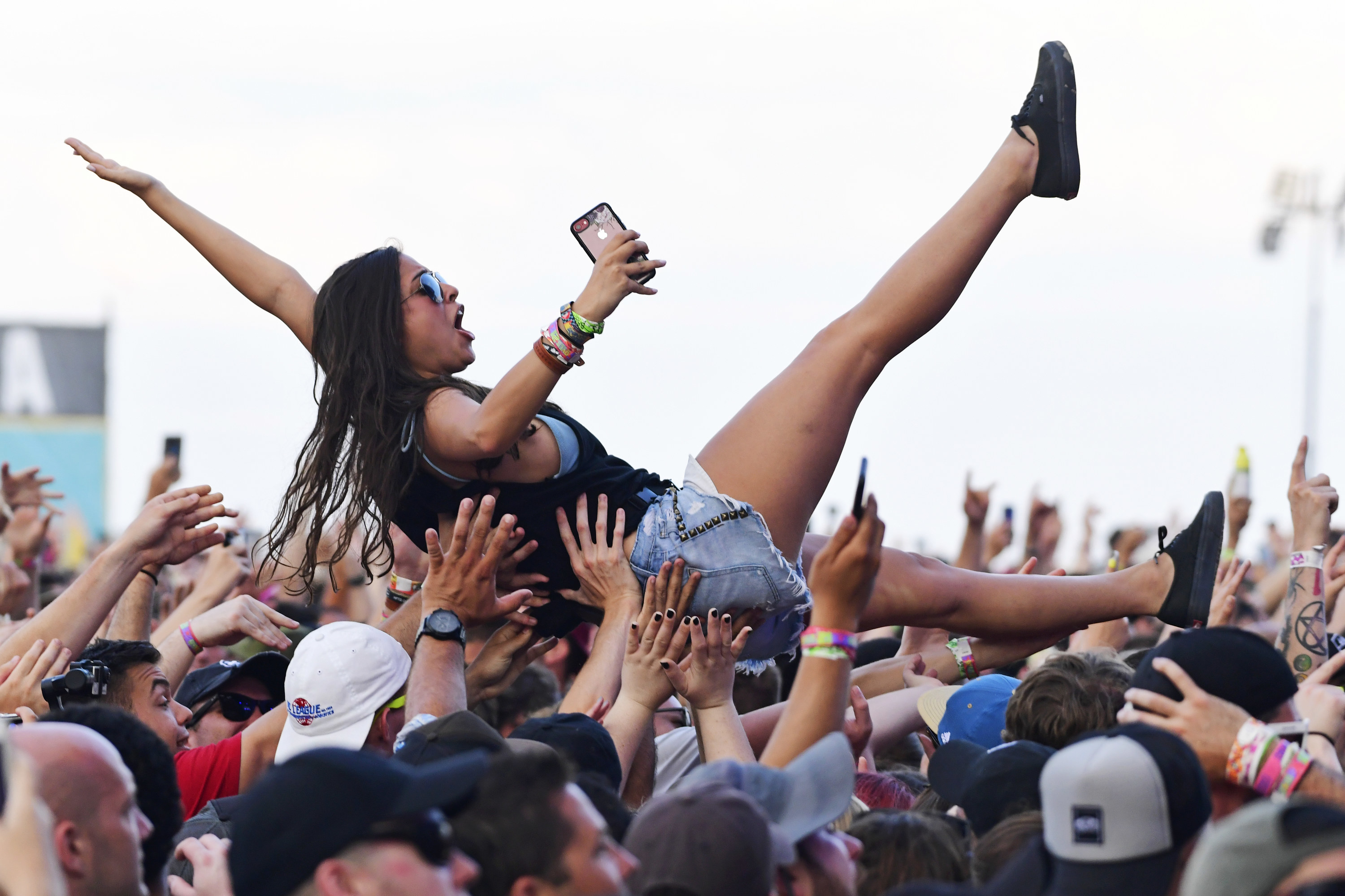 A woman crowd surfing at the 2019 Vans Warped Tour