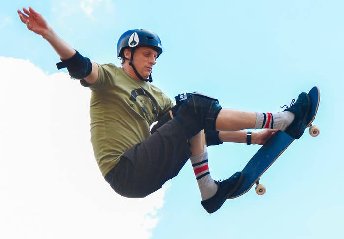 Tony flies through the air on his skateboard