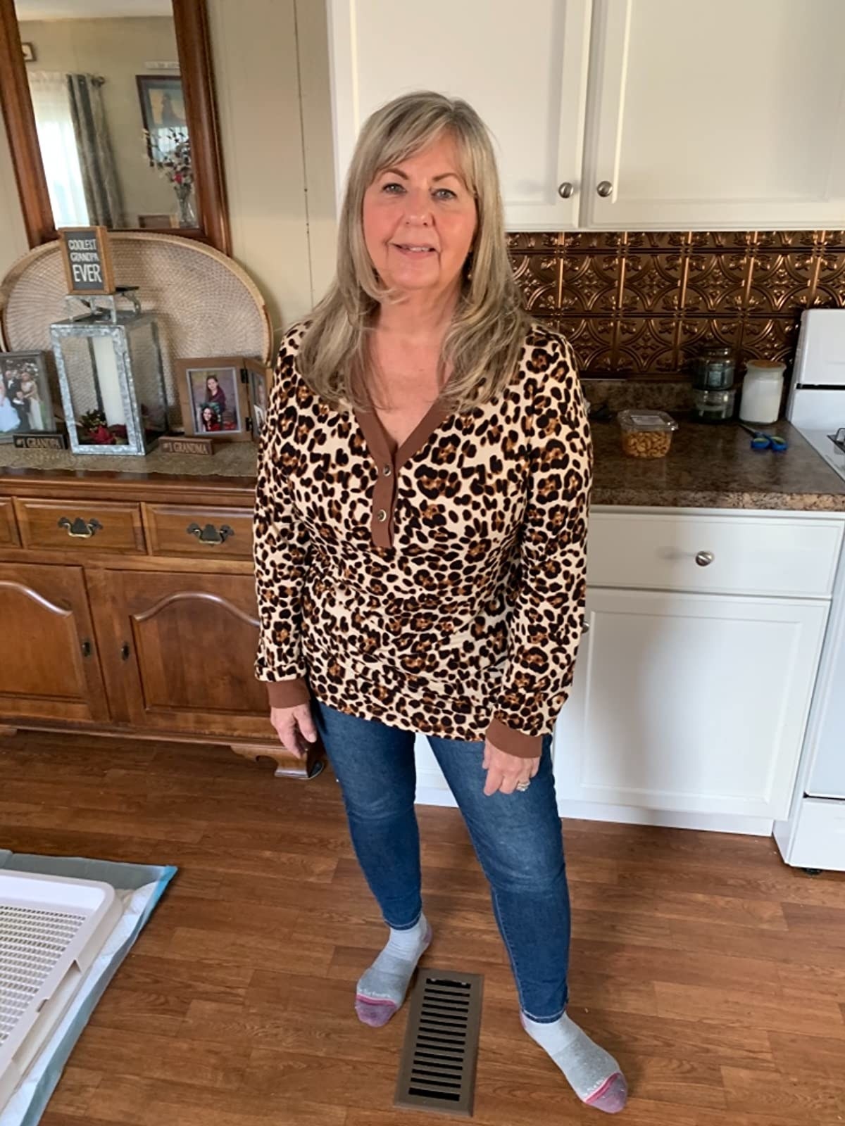 reviewer wearing the long sleeve henley top in leopard print