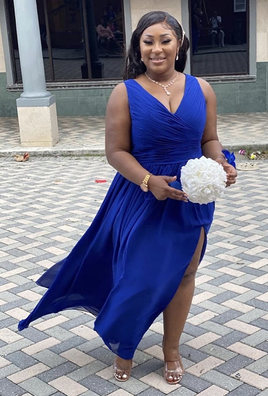 a reviewer wearing the dress in a deep royal blue color