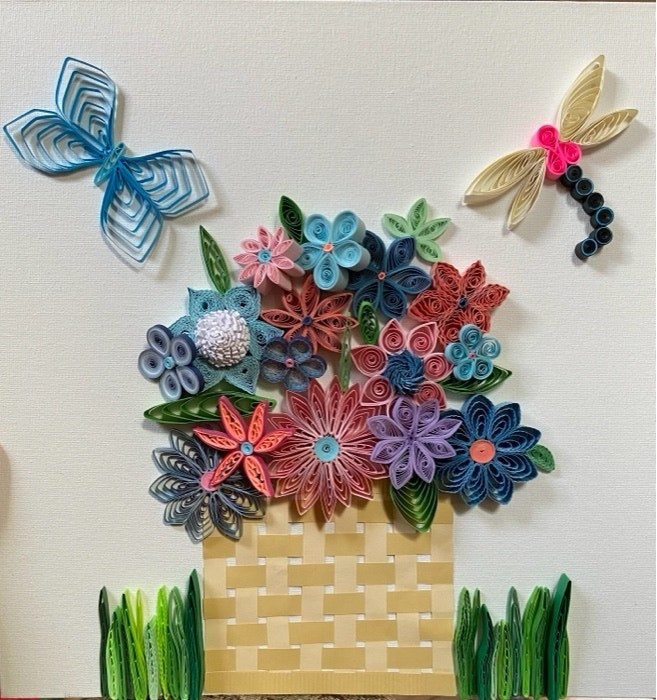 Paper quilled drawing of a basket overflowing with flowers and butterflies